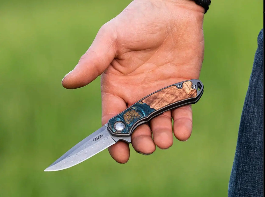 man holding carved pocket knife