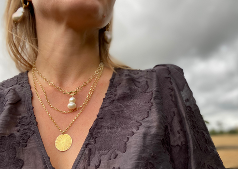 Image of some of the RAW Copenhagen designs featuring the textures hammered pendant and freshwater pearls
