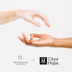 Two hands reaching out to each other and RevitaLash Cosmetics logo + City of Hope logo