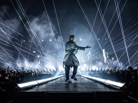 The Weeknd walks across the stage as he sings for the audience