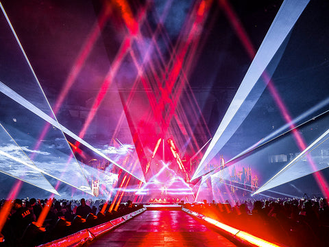 Red and white beams of light mark the stage path for the singer