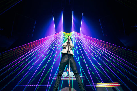Brednon Urie performs on stage with lasers