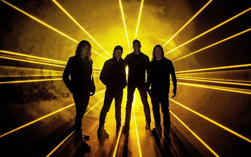 Metallica stands in front of yellow laser beams