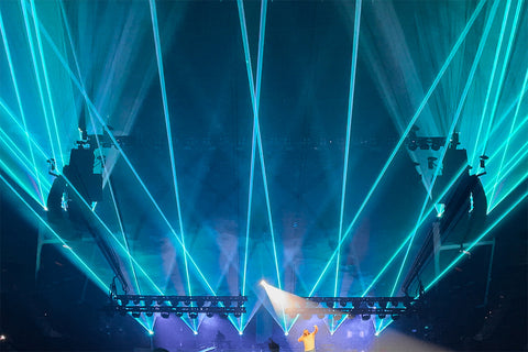 Blue beams shine over the audience