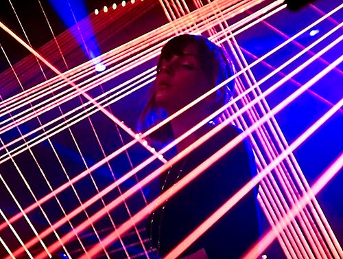 Chvrches singer standing in laser light
