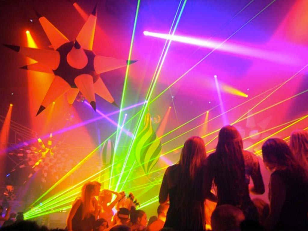 Green aerial laser beams inside of nightclub