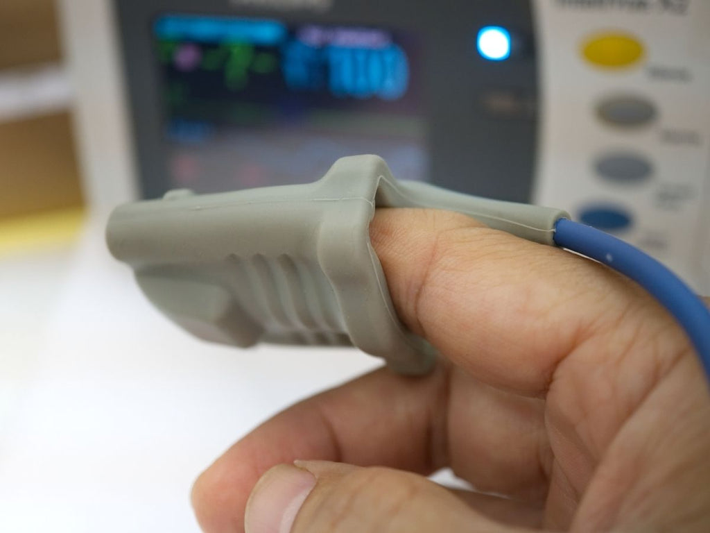 Typical pulse oximeter used at a hospital - fingertip probe attached to patient
