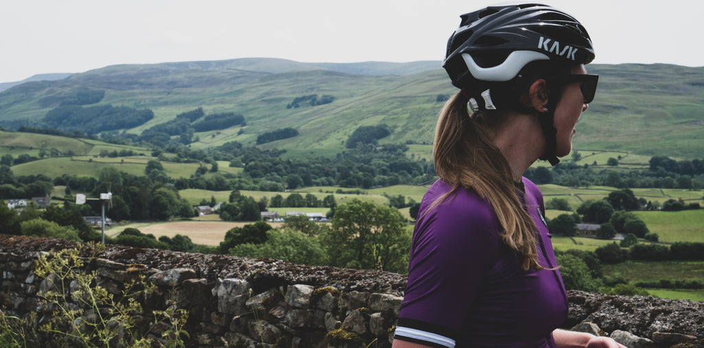 Views over the lune valley, Cumbria. Esme wears the sweet spot gab up purple cycling jersey
