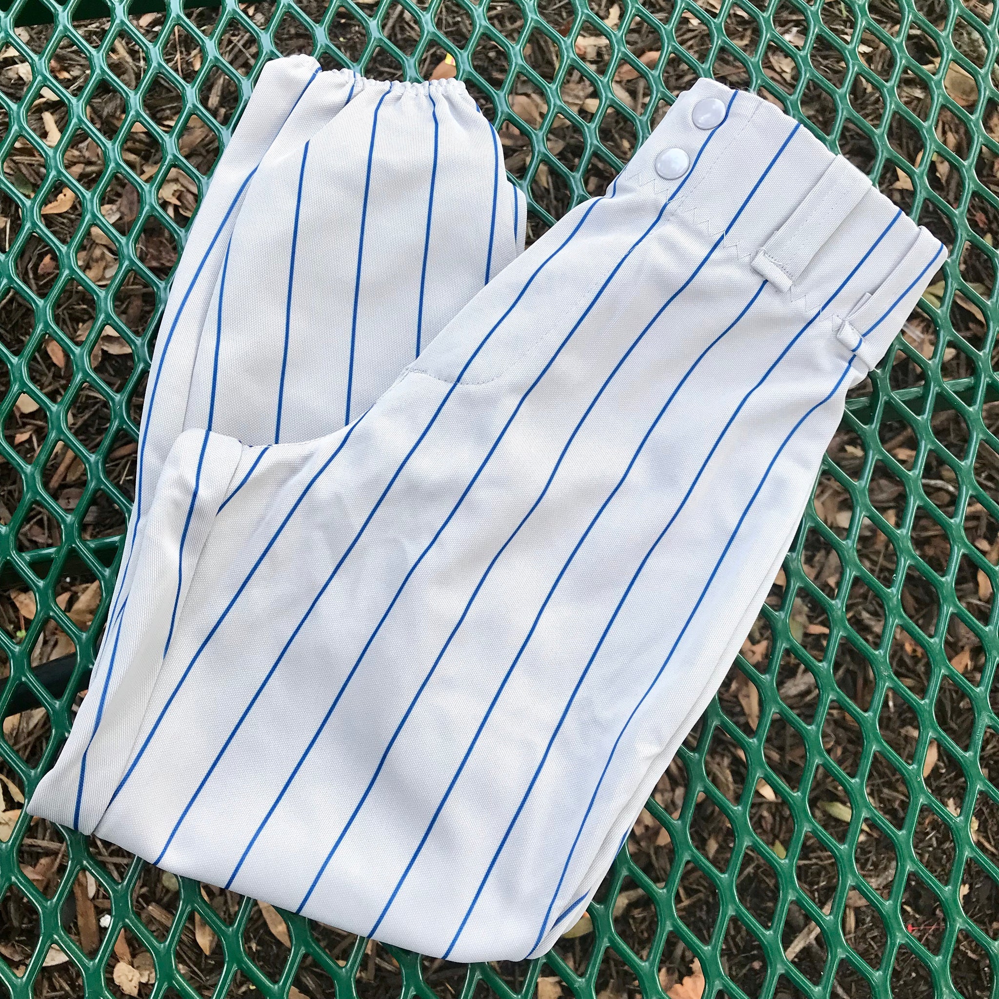 gray baseball pants with blue stripe