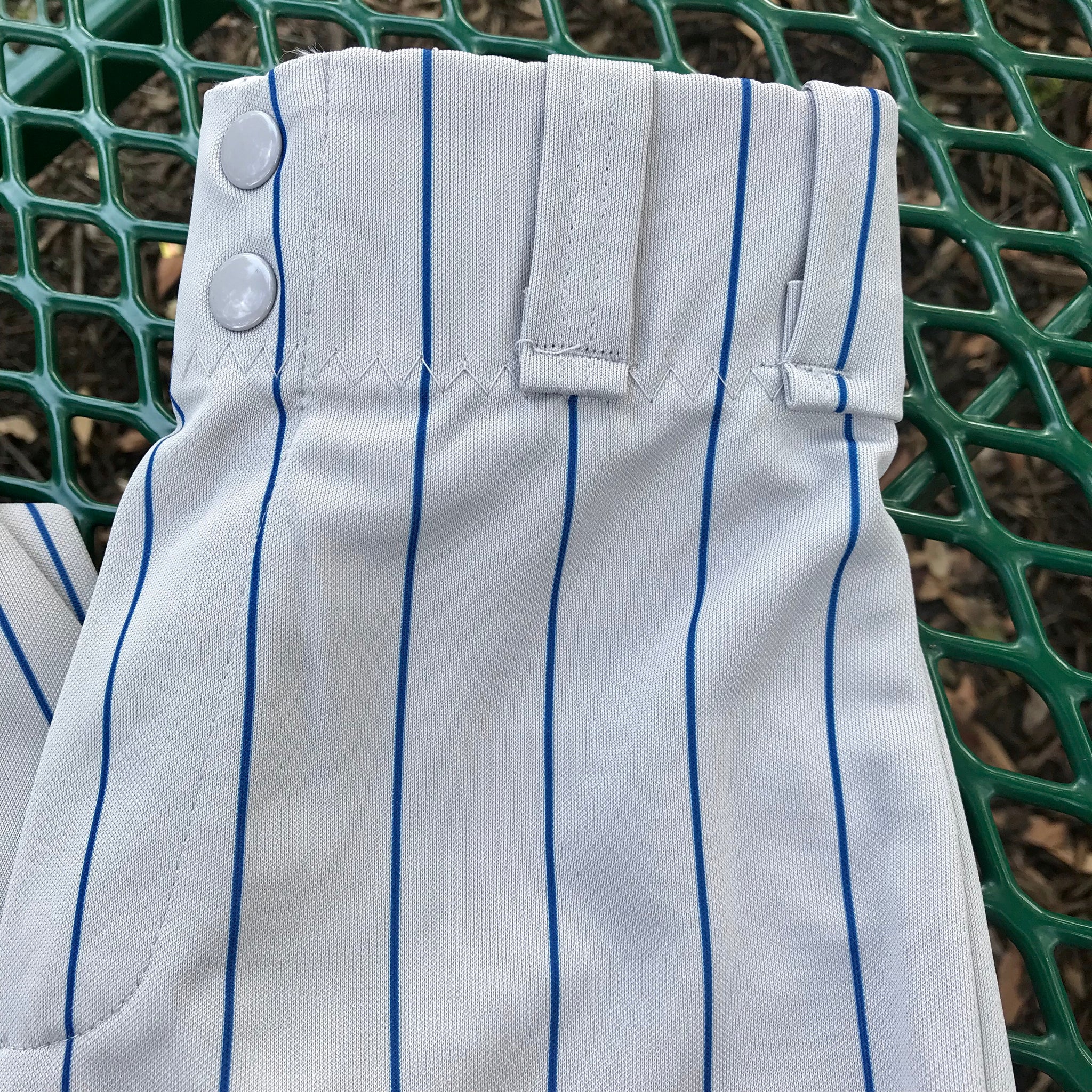 gray baseball pants with blue stripe