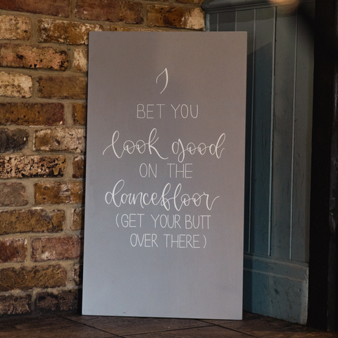 grey wedding sign, hand lettered in calligraphy with song quote 