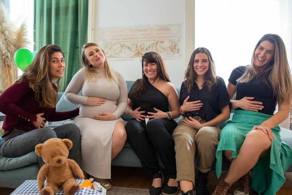people sitting on a couch during a baby shower party