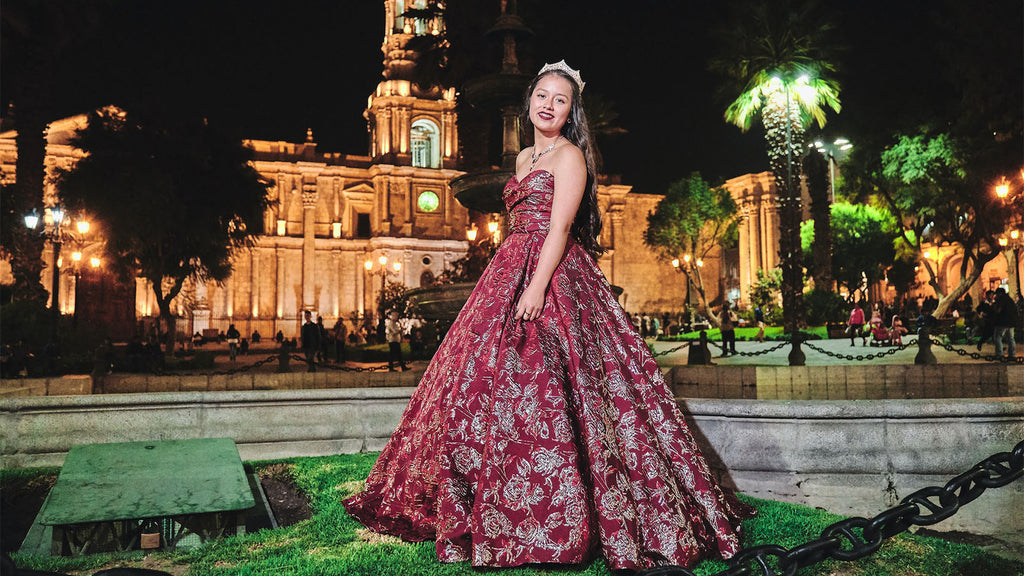 girl with red dress getting photographed for her quinceanera