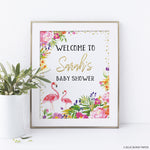 Flamingo Baby Shower Welcome Sign with a gold frame and a plant in a pot next to it