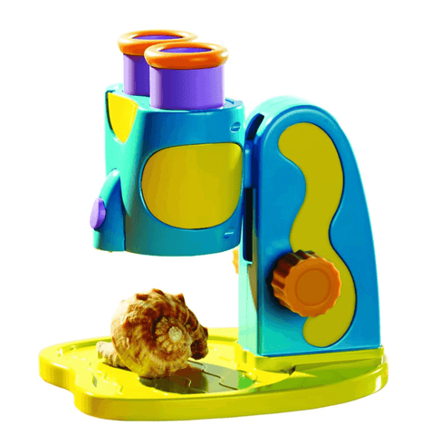 Colourful childrens microscope focusing on a seashell
