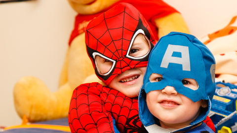Two children dressed as spiderman and captain america