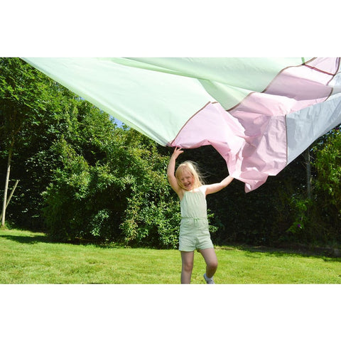 Young girl playing outside with the Giant Play Parachute
