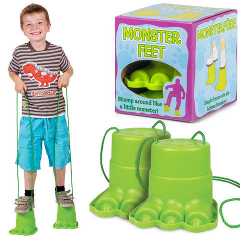 Little boy smiling as he wears the Monster Feet toys with holding strings