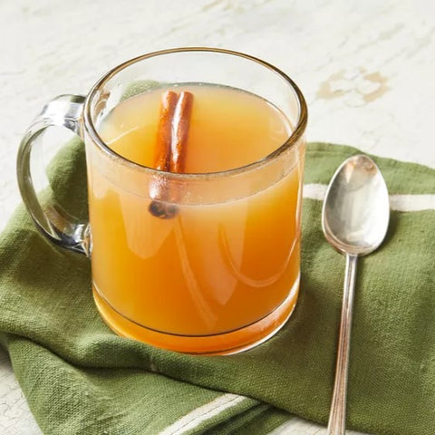 Cider served with a cinnamon stick