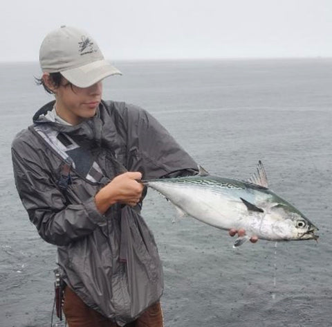 Shop employee Louis Schlaker with a rainy day albie caught this week. (@rhodysurfcasting)