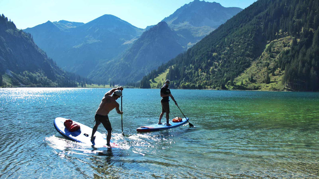 Two standup paddlers on the remote Tyrolean lake Vilsalpsee