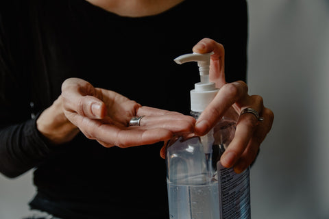 hand sanitzer being applied to woman's hand