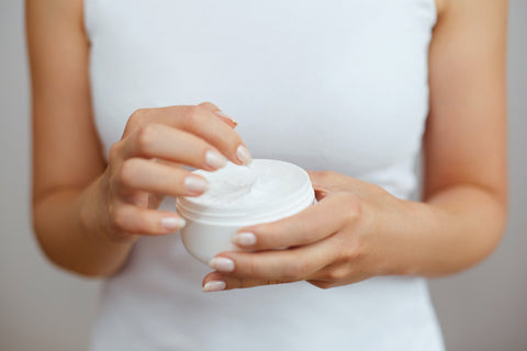 women holding lotion made with essential oil