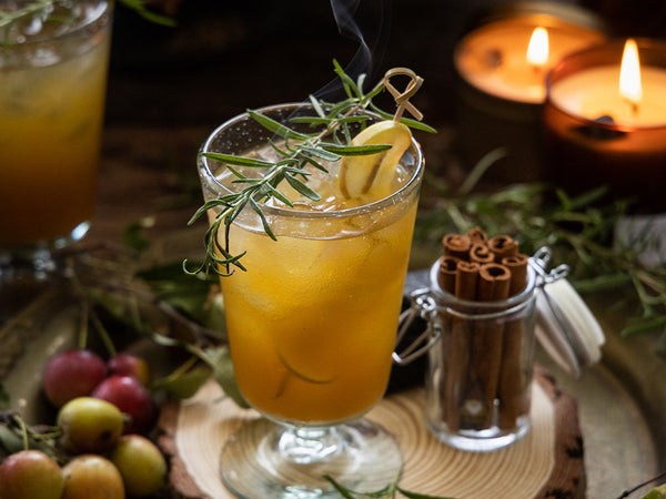 Autumn Inspired Cocktail in a glass on a styled table with candles