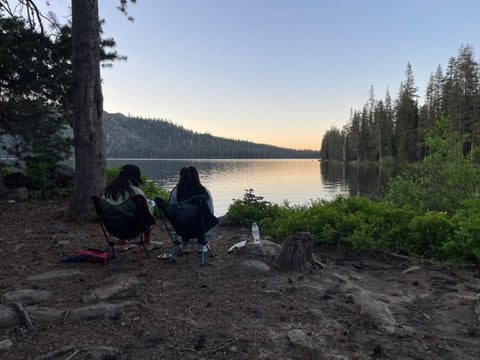Two girls sitting by Gold Lake