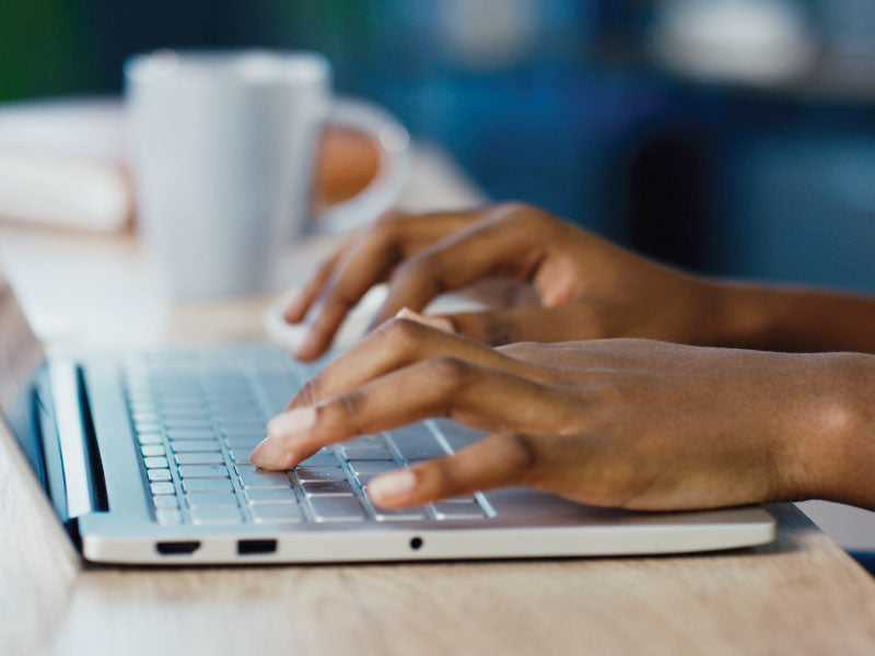 Person typing on keyboard