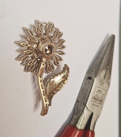 jewelry piece with pliers on the side