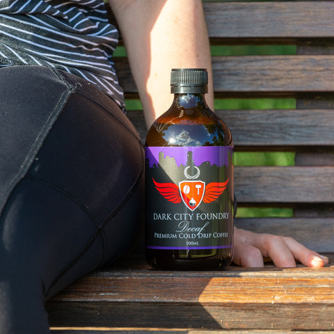 500ml cold brew coffee bottle pictured with owner Anita Brodian on a park bench