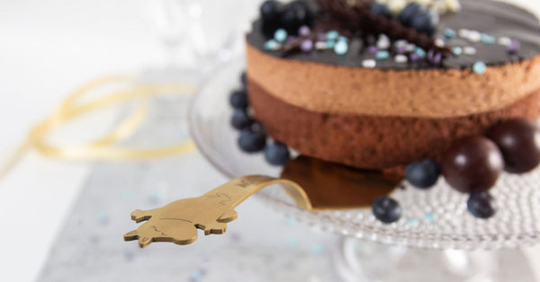 cake on a platter with Moomin gold cake server