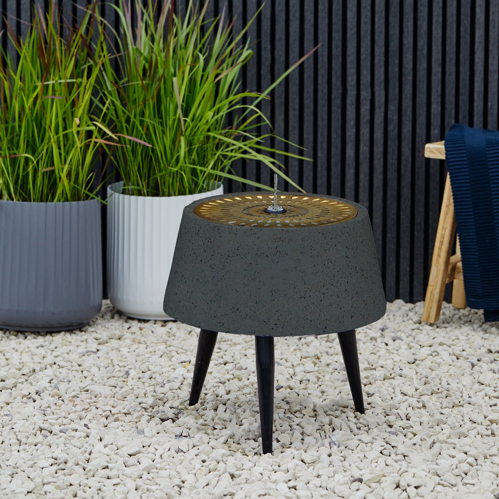 Product photograph of Ivyline Solis Water Feature With Light Display On Black Legs In Charcoal Aged Copper from Olivia's.