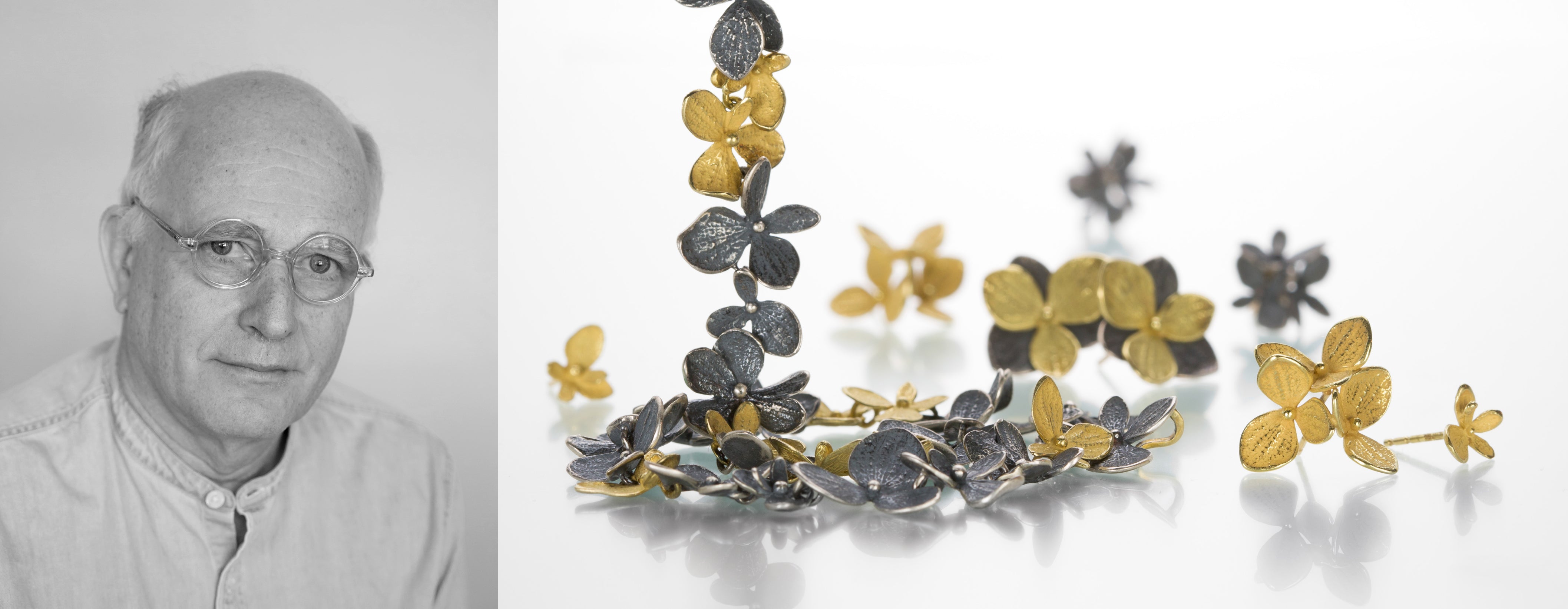 Jewelry designer and artist John Iversen photographed alongside his jewelry collection featuring an 18k yellow gold and oxidized sterling silver hydrangea necklace, 18k yellow gold hydrangea earrings and oxidized sterling silver hydrangea earrings