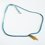 Blue silk rope necklace with brass pendants