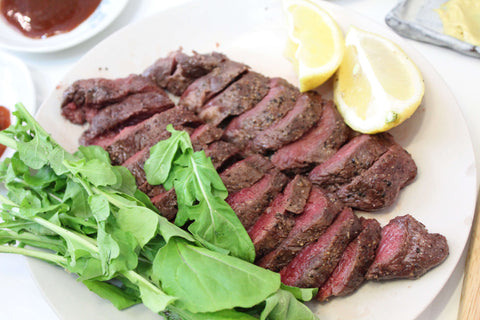 Kangaroo Steak on a plate with herbs