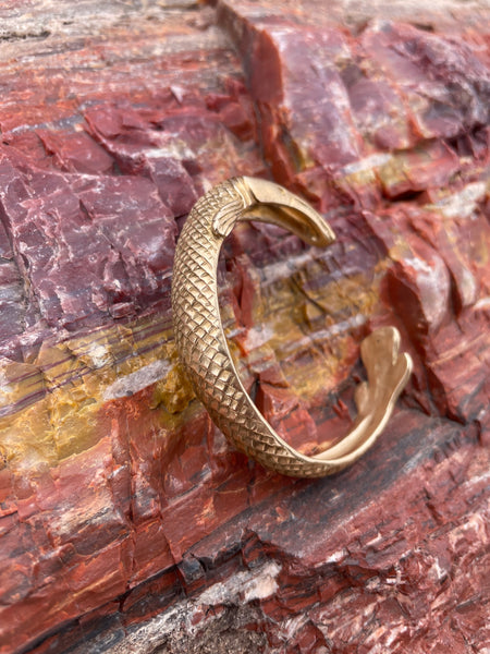 MIMOSA Handcrafted's Garfish Bracelet Rests on a Petrified Tree