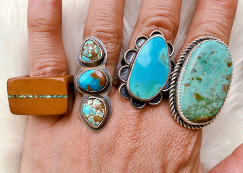 Madeline wears turquoise jewelry rings from Beneath the Bark, Bayou Bohemian, Meltdown Studio, and one unknown artist