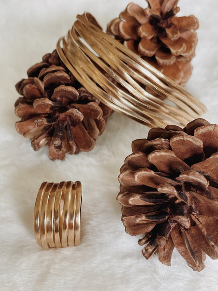 MIMOSA Handcrafted's Loblolly Pine Needle Jewelry is Displayed Alongside Pinecones