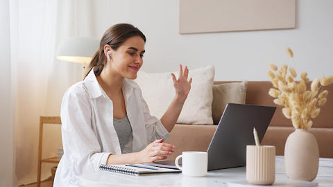 Woman smiling while using computer