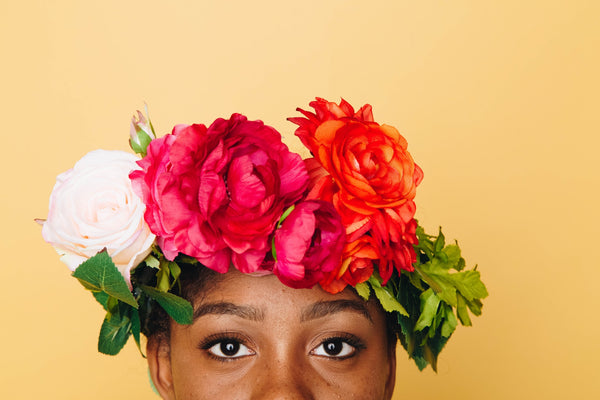 woman with a flower crown on a yellow background