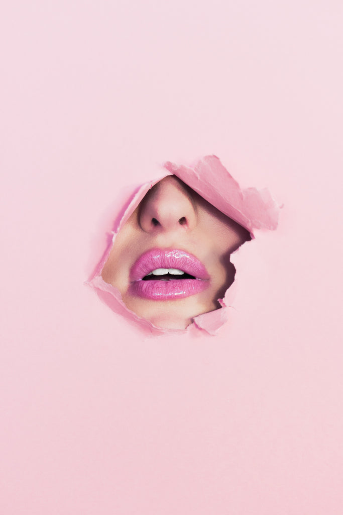 pink paper hole surrounding a mouth and nose