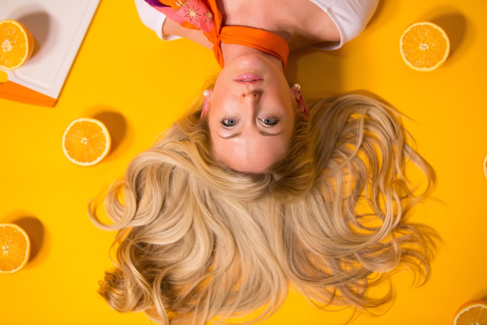 woman with blonde hair and oranges