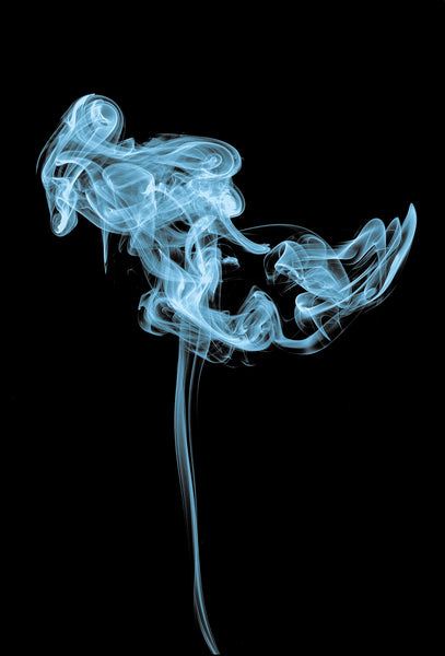 curl of blue smoke on a black background