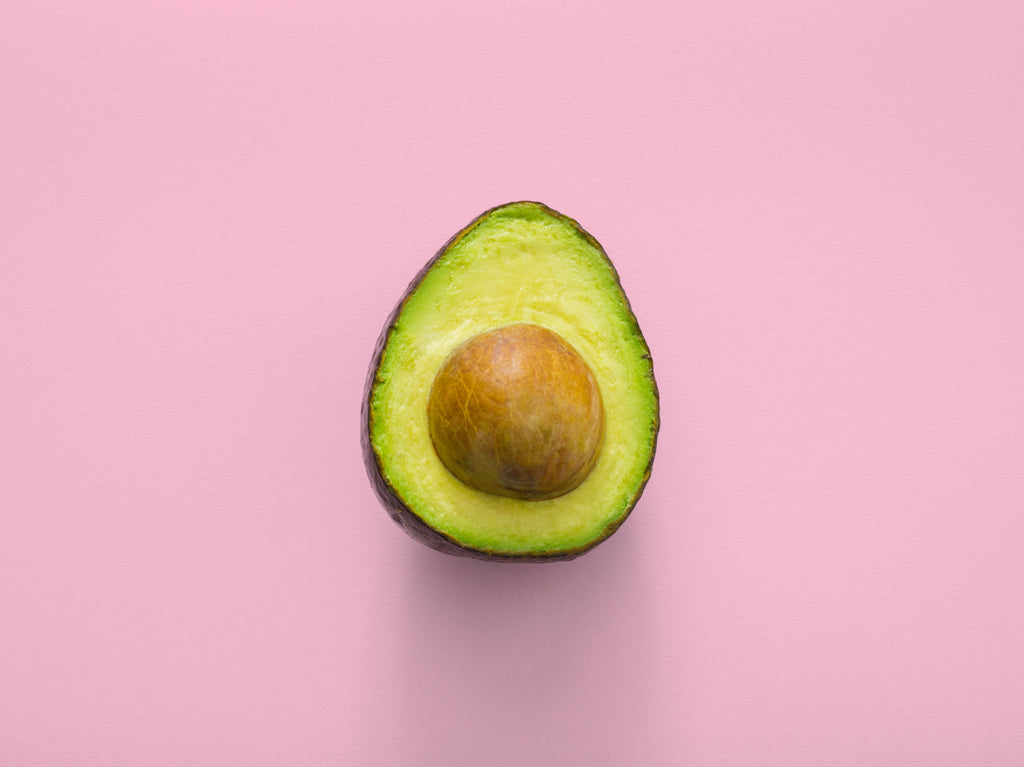 half avocado on a pink background
