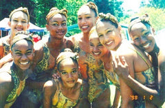 Philicia and her team wearing head wraps and African print swimsuits