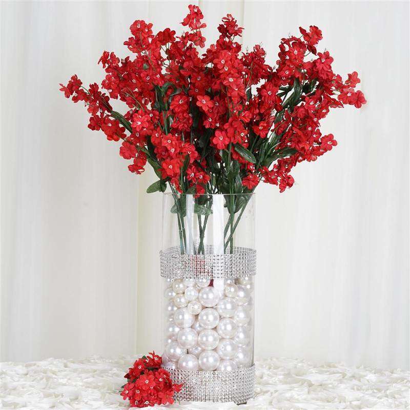 red artificial flowers in vase