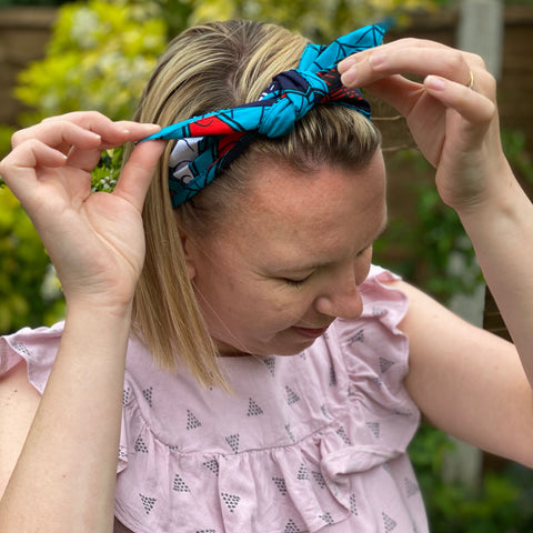 close up of a person tying up a head wrap