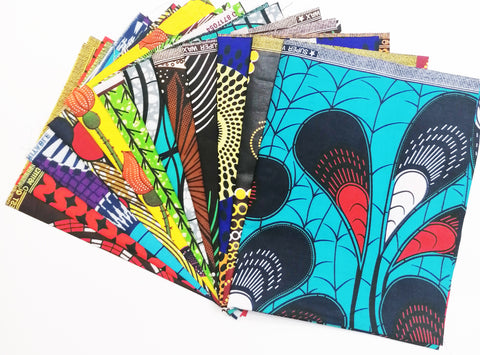 A bundle of african wax print fat quarters with a blue colour at the front and many other colours at the back.
